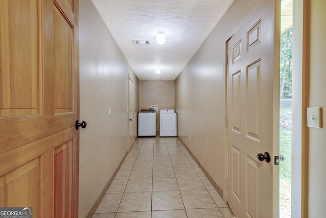 351 Weldon Rd, Palmetto, GA 30268 - hallway with washer and clothes dryer, light tile patterned flooring, a textured ceiling, and plenty of natural light