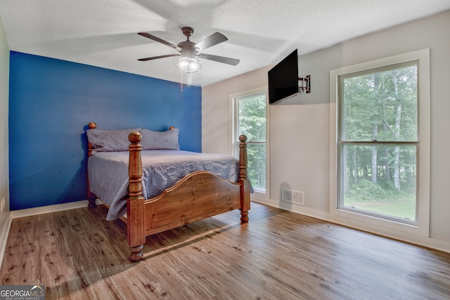 351 Weldon Rd, Palmetto, GA 30268 - bedroom with wood finished floors, a textured ceiling, and a ceiling fan