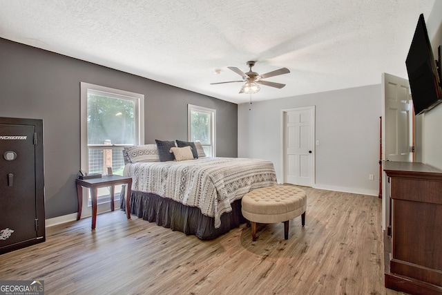 351 Weldon Rd, Palmetto, GA 30268 - bedroom featuring light wood-style flooring, a textured ceiling, and ceiling fan