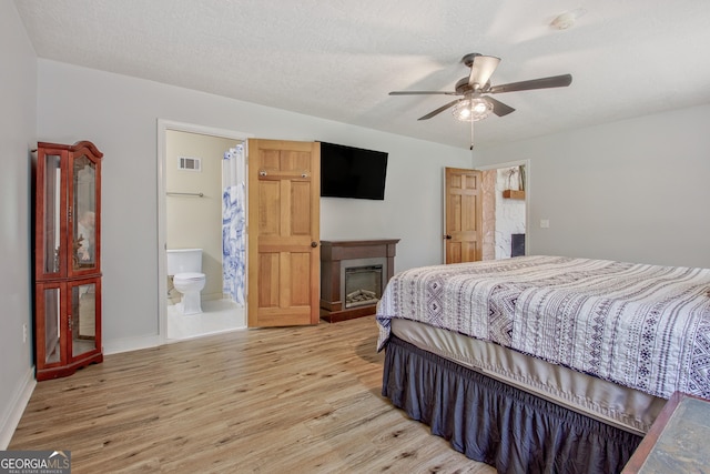 351 Weldon Rd, Palmetto, GA 30268 - bedroom with a fireplace, light wood finished floors, ensuite bathroom, and ceiling fan