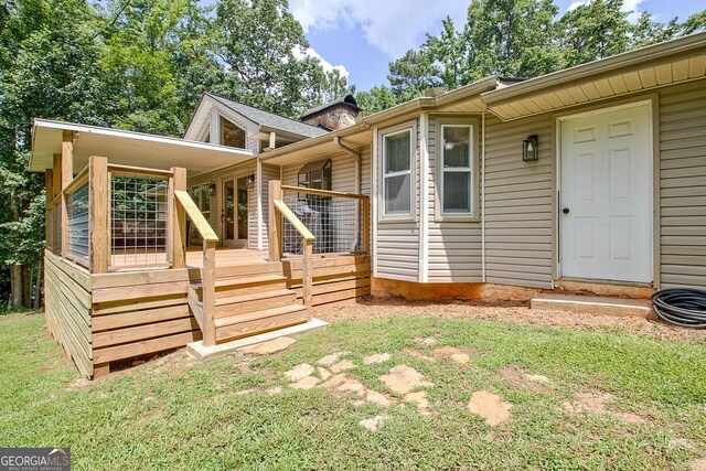 351 Weldon Rd, Palmetto, GA 30268 - view of exterior entry featuring a wooden deck and a lawn
