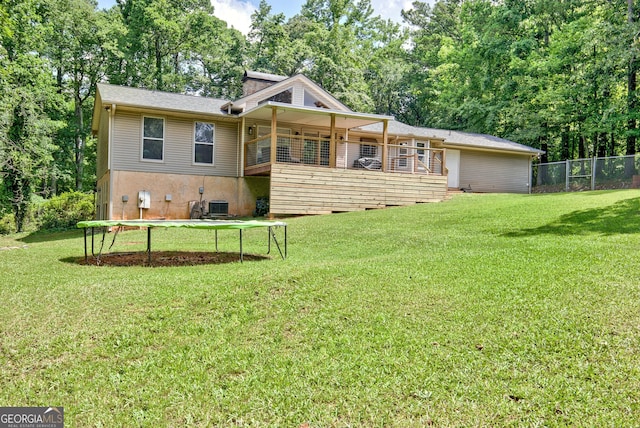 351 Weldon Rd, Palmetto, GA 30268 - back of house with a trampoline and view of wooded area