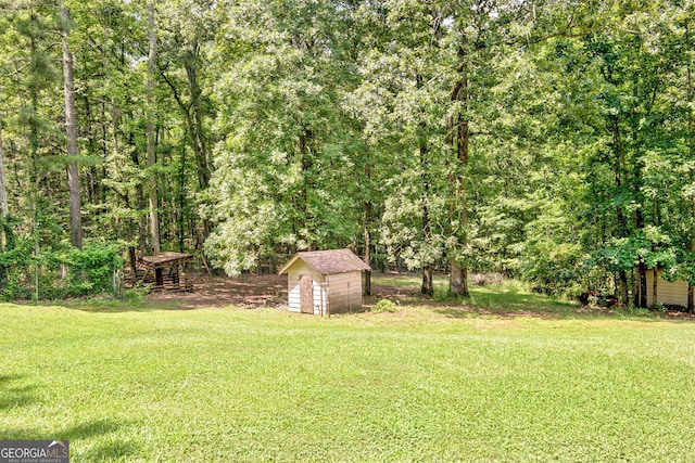 351 Weldon Rd, Palmetto, GA 30268 - view of green lawn featuring a storage shed