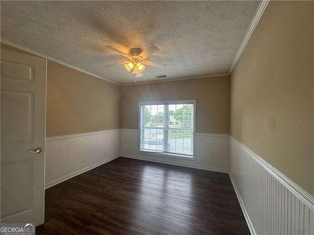 4189 Duncan Ives Dr, Buford, GA 30519 - unfurnished room with wood finished floors, ceiling fan, a wainscoted wall, a textured ceiling, and crown molding