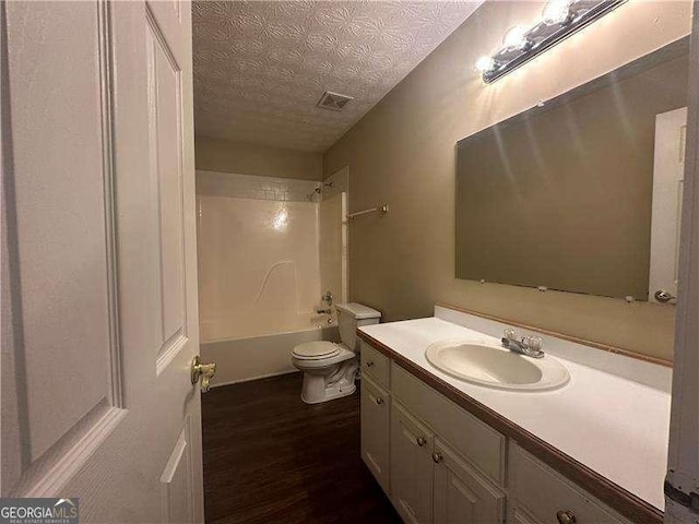 4189 Duncan Ives Dr, Buford, GA 30519 - full bath featuring vanity, wood finished floors, a textured ceiling, and bathing tub / shower combination