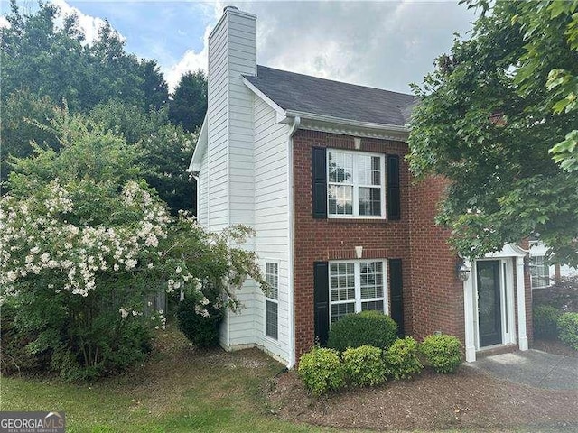 4189 Duncan Ives Dr, Buford, GA 30519 - view of property exterior with a chimney and brick siding