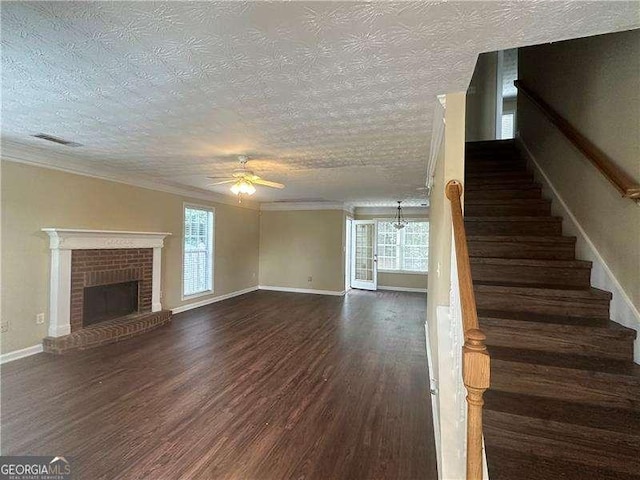 4189 Duncan Ives Dr, Buford, GA 30519 - unfurnished living room with ceiling fan, dark wood-type flooring, stairway, a fireplace, and ornamental molding