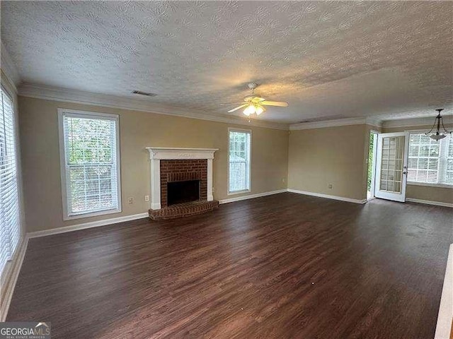 4189 Duncan Ives Dr, Buford, GA 30519 - unfurnished living room with dark wood-style flooring, ceiling fan, a textured ceiling, a brick fireplace, and plenty of natural light