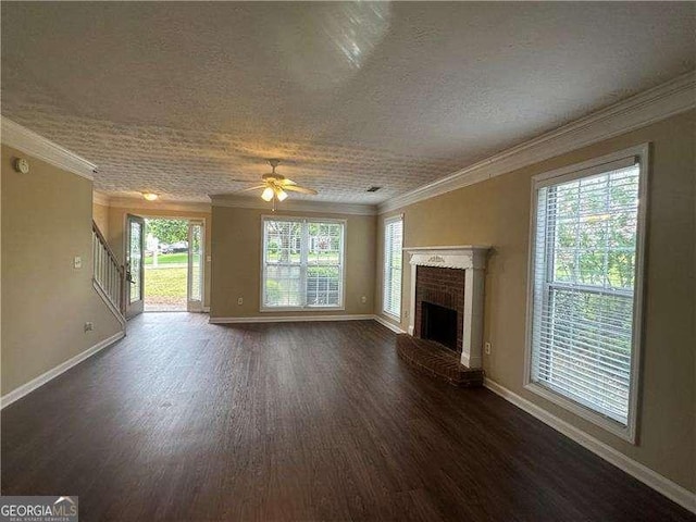 4189 Duncan Ives Dr, Buford, GA 30519 - unfurnished living room featuring dark wood finished floors, a brick fireplace, ceiling fan, ornamental molding, and stairs
