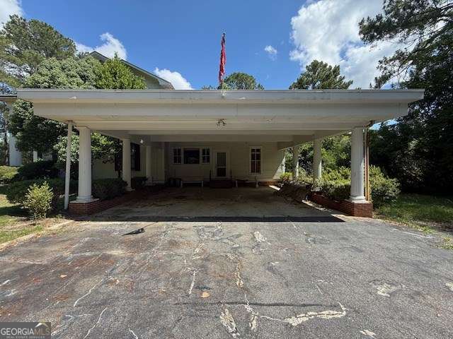 2205 Wilson Ave, Tifton, GA 31794 - view of parking with asphalt driveway and a carport