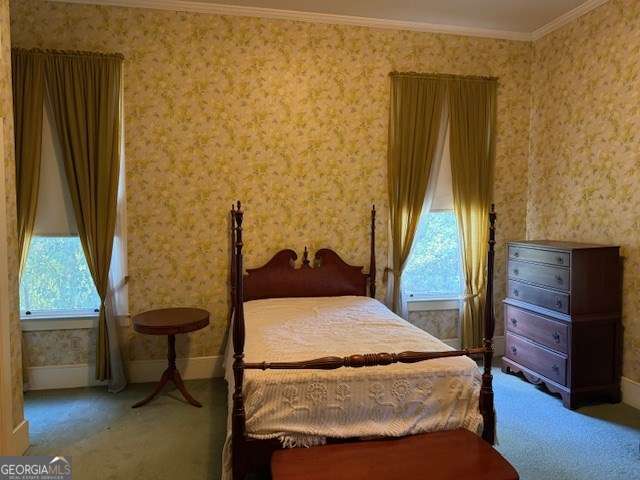 2205 Wilson Ave, Tifton, GA 31794 - carpeted bedroom with wallpapered walls, multiple windows, and crown molding