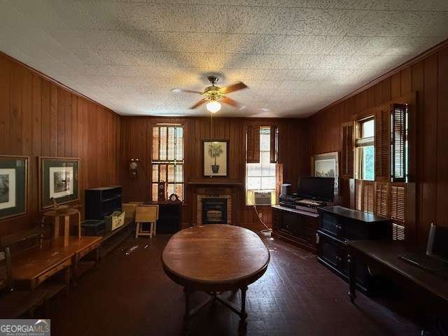 2205 Wilson Ave, Tifton, GA 31794 - living room featuring healthy amount of natural light, a brick fireplace, ceiling fan, and wood walls