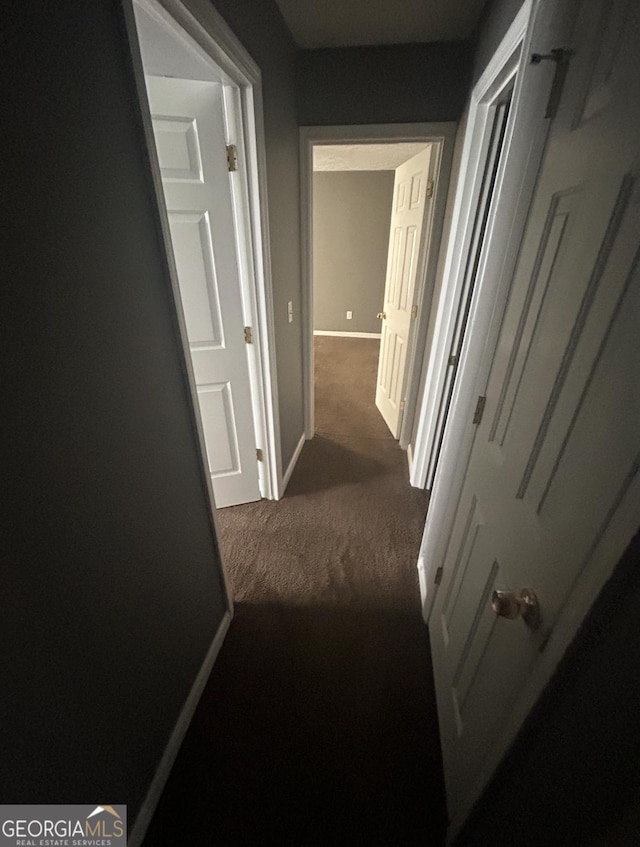 6470 Bedford Ln, Lithonia, GA 30058 - corridor featuring dark carpet and baseboards
