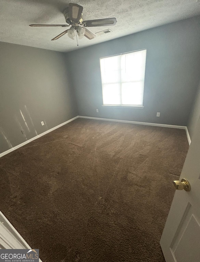 6470 Bedford Ln, Lithonia, GA 30058 - spare room with a ceiling fan, a textured ceiling, and dark carpet
