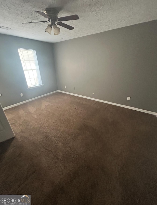 6470 Bedford Ln, Lithonia, GA 30058 - unfurnished room with ceiling fan, a textured ceiling, and dark carpet