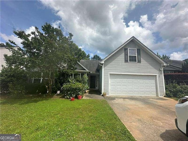 1241 Key Manor Ln, Lawrenceville, GA 30045 - view of front facade featuring driveway, a front yard, and an attached garage