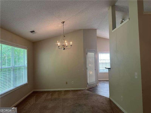 1241 Key Manor Ln, Lawrenceville, GA 30045 - unfurnished dining area with plenty of natural light, carpet, a chandelier, lofted ceiling, and a textured ceiling