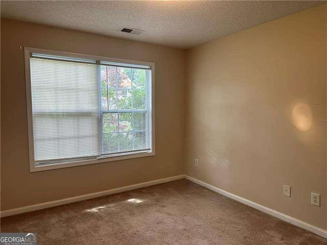 1241 Key Manor Ln, Lawrenceville, GA 30045 - carpeted empty room featuring a textured ceiling and baseboards