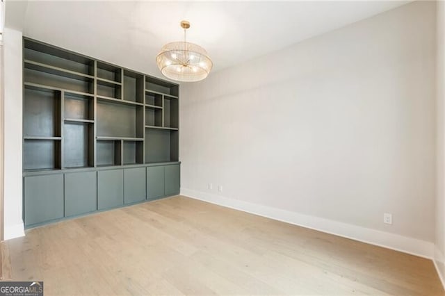 15792 Thompson Rd, Milton, GA 30004 - empty room with a chandelier and wood finished floors