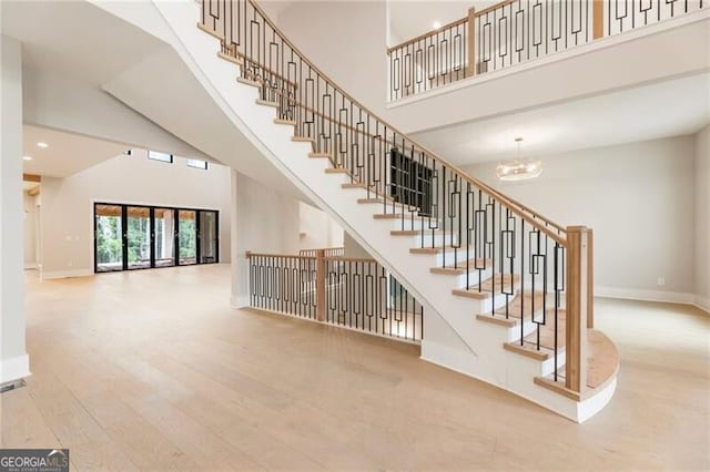 15792 Thompson Rd, Milton, GA 30004 - stairway with a towering ceiling, wood finished floors, a chandelier, and recessed lighting