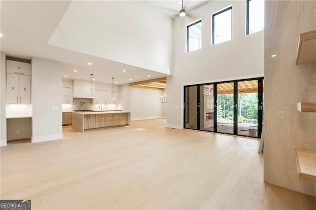15792 Thompson Rd, Milton, GA 30004 - unfurnished living room featuring a high ceiling, light wood-type flooring, recessed lighting, and a ceiling fan