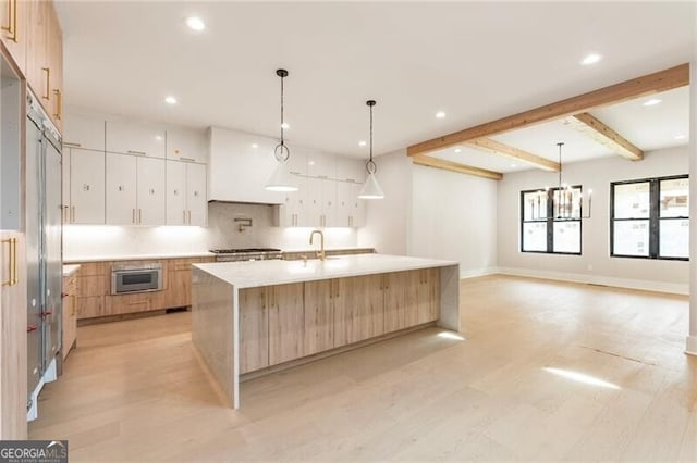 15792 Thompson Rd, Milton, GA 30004 - kitchen with stainless steel gas stovetop, modern cabinets, light countertops, light wood-style flooring, and recessed lighting