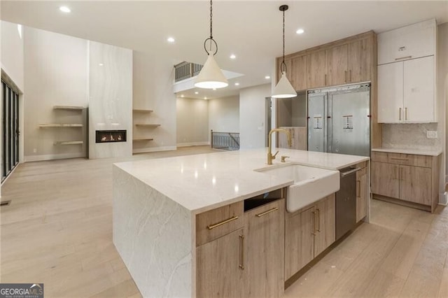 15792 Thompson Rd, Milton, GA 30004 - kitchen featuring modern cabinets, recessed lighting, a large island with sink, stainless steel dishwasher, and light stone counters