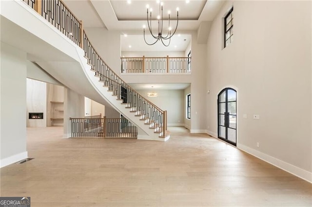 15792 Thompson Rd, Milton, GA 30004 - entryway with wood finished floors, stairway, a chandelier, a towering ceiling, and recessed lighting