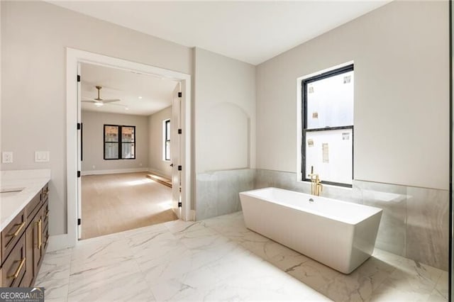 15792 Thompson Rd, Milton, GA 30004 - full bathroom featuring a freestanding tub, vanity, ceiling fan, marble finish flooring, and tile walls