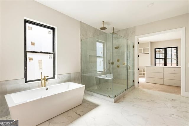 15792 Thompson Rd, Milton, GA 30004 - bathroom featuring a shower stall, marble finish floors, a soaking tub, and tile walls