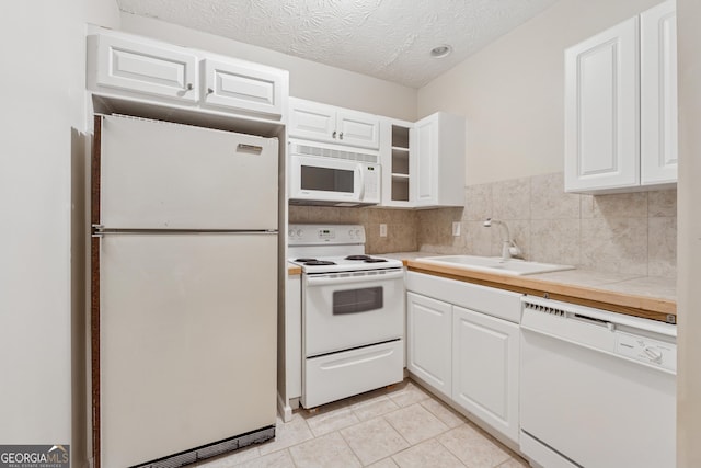 384 Daniel Mill Xing, Villa Rica, GA 30180 - kitchen with white appliances, white cabinets, light tile patterned floors, and a textured ceiling