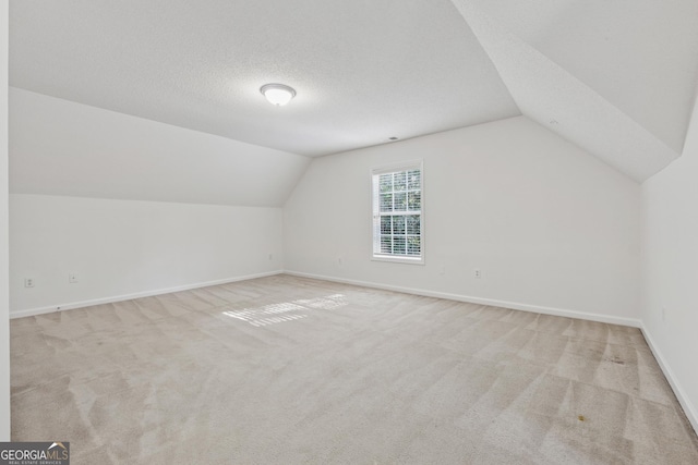 384 Daniel Mill Xing, Villa Rica, GA 30180 - additional living space featuring carpet and vaulted ceiling