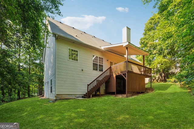 384 Daniel Mill Xing, Villa Rica, GA 30180 - back of property with stairway, a wooden deck, a chimney, and a lawn