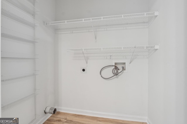 384 Daniel Mill Xing, Villa Rica, GA 30180 - washroom with electric dryer hookup, light wood-style flooring, and washer hookup