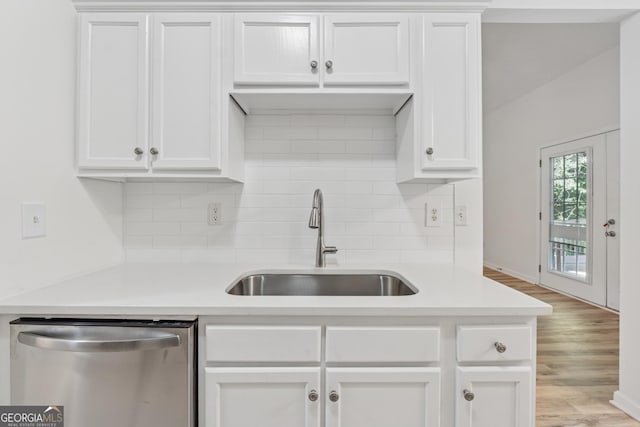 384 Daniel Mill Xing, Villa Rica, GA 30180 - kitchen featuring stainless steel dishwasher, light countertops, decorative backsplash, and white cabinetry
