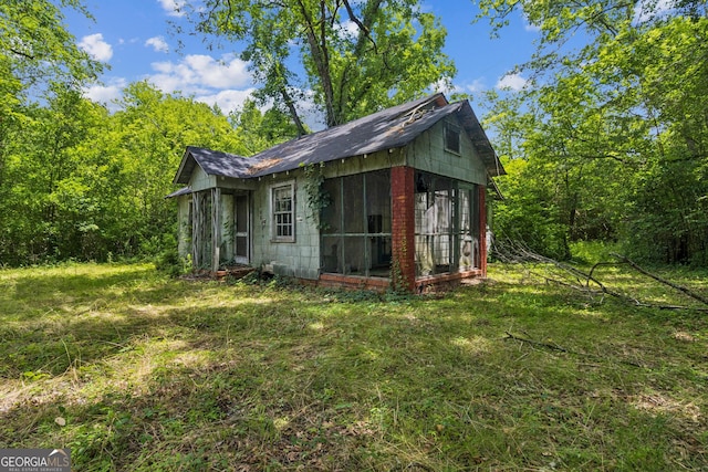 1494 Jeffersonville Rd, Macon, GA 31217 - view of property exterior featuring a sunroom and a yard