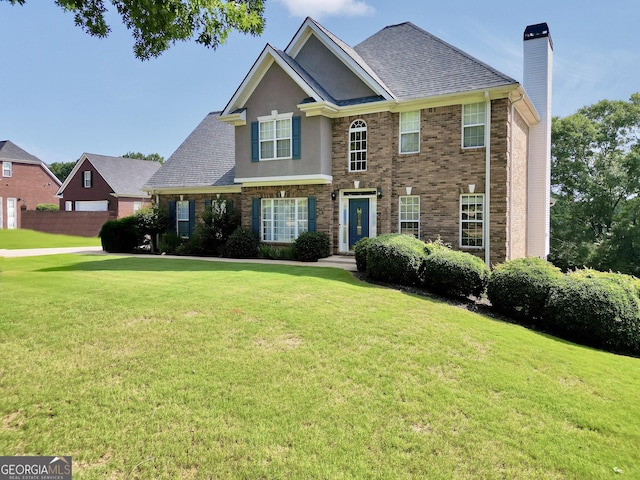 106 Big Cotton Trl, Mcdonough, GA 30252 - view of front of house with a chimney, a front yard, and roof with shingles