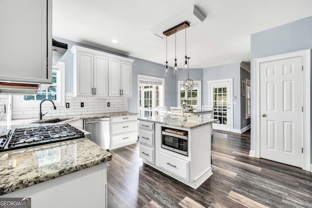 106 Big Cotton Trl, Mcdonough, GA 30252 - kitchen with stainless steel appliances, decorative backsplash, white cabinets, pendant lighting, and light stone counters