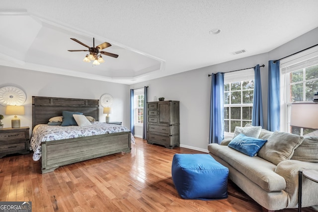 106 Big Cotton Trl, Mcdonough, GA 30252 - bedroom featuring a tray ceiling, light wood finished floors, and a ceiling fan