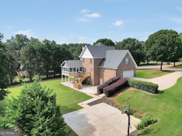 106 Big Cotton Trl, Mcdonough, GA 30252 - rear view of property with brick siding, stairway, a yard, and a garage