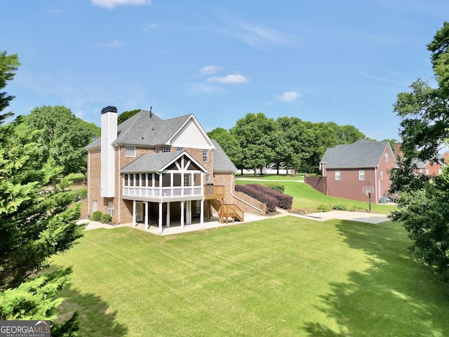 106 Big Cotton Trl, Mcdonough, GA 30252 - back of property featuring brick siding, a wooden deck, stairway, and a patio