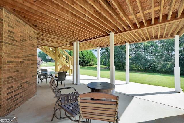 106 Big Cotton Trl, Mcdonough, GA 30252 - view of patio with outdoor dining area, stairs, and view of wooded area