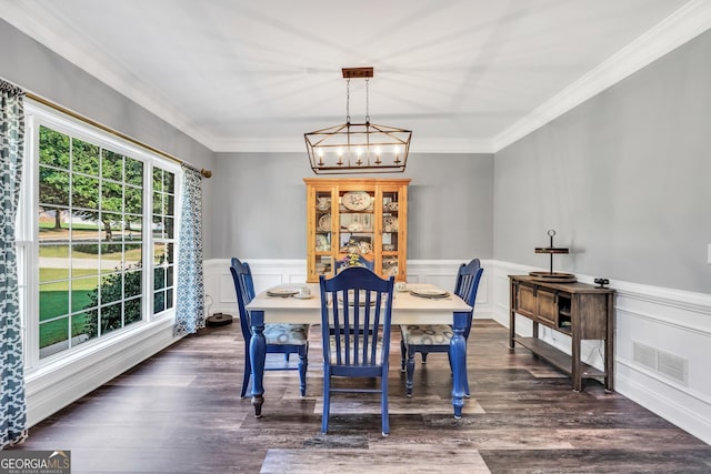 106 Big Cotton Trl, Mcdonough, GA 30252 - dining area featuring a chandelier, ornamental molding, a wainscoted wall, dark wood finished floors, and a decorative wall