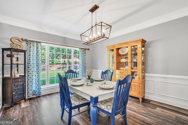 106 Big Cotton Trl, Mcdonough, GA 30252 - dining room featuring crown molding, a chandelier, dark wood-type flooring, and a wainscoted wall