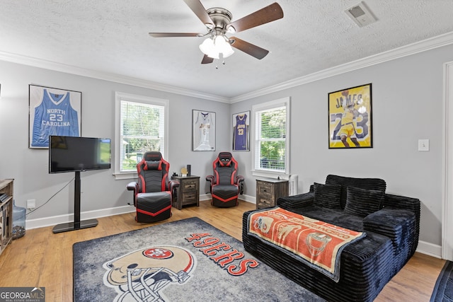 2421 Pittman Cir, Cumming, GA 30040 - living room with plenty of natural light, ornamental molding, ceiling fan, wood finished floors, and a textured ceiling