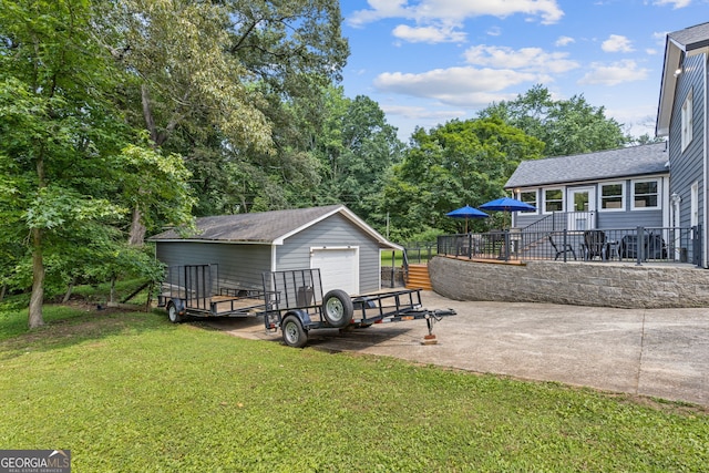 2421 Pittman Cir, Cumming, GA 30040 - view of yard featuring a detached garage, an outbuilding, and concrete driveway