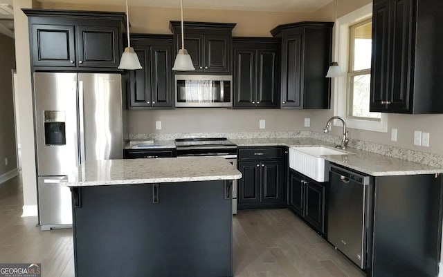 0 Nocona Trl, Ellijay, GA 30536 - kitchen featuring stainless steel appliances, a center island, light stone counters, pendant lighting, and dark cabinets