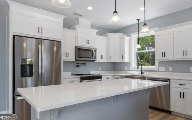 0 Nocona Trl, Ellijay, GA 30536 - kitchen with stainless steel appliances, a breakfast bar, white cabinetry, and recessed lighting