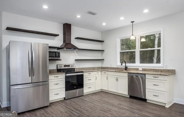 0 Nocona Trl, Ellijay, GA 30536 - kitchen featuring appliances with stainless steel finishes, open shelves, wall chimney exhaust hood, light stone countertops, and dark wood-style flooring
