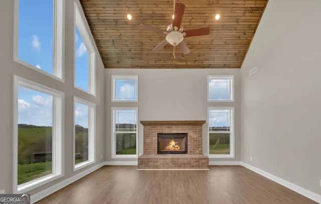 0 Nocona Trl, Ellijay, GA 30536 - unfurnished living room featuring wood ceiling, a ceiling fan, high vaulted ceiling, wood finished floors, and a fireplace